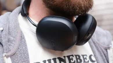 Close-up of black headphones around a person's neck.