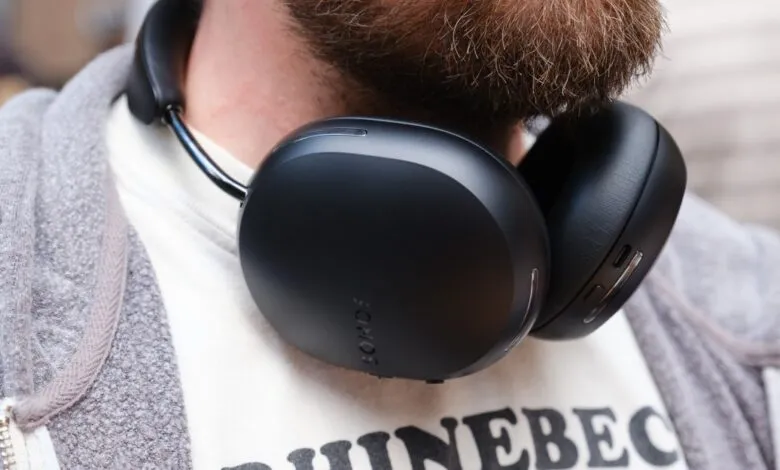 Close-up of black headphones around a person's neck.