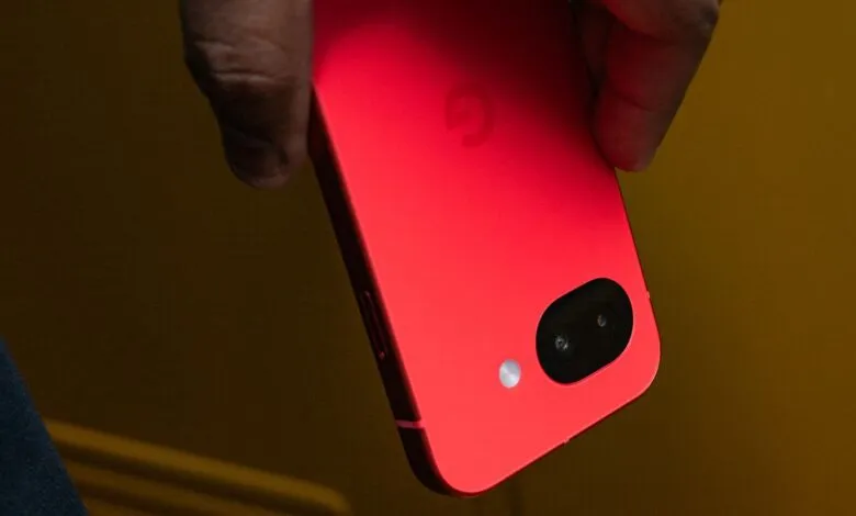 Close-up of a vibrant red Google Pixel phone held in someone's hand.