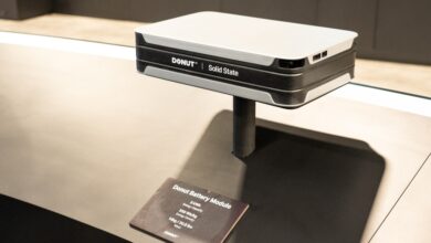 Donut Solid State battery module on display stand with product information card.