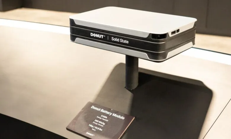 Donut Solid State battery module on display stand with product information card.
