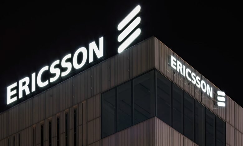 Ericsson building at night with illuminated logo and signage.