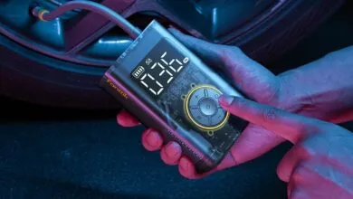 Fanttik X9 Pro portable tire inflator being used on a car tire.