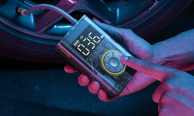 Fanttik X9 Pro portable tire inflator being used on a car tire.
