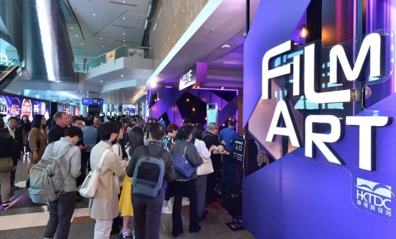 Crowd of people entering Filmart trade show in Hong Kong.