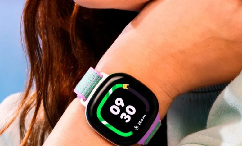 Fitbit Ace LTE smartwatch on wrist, displaying time and activity tracking.