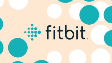 Fitbit logo on a background of teal and white circles.