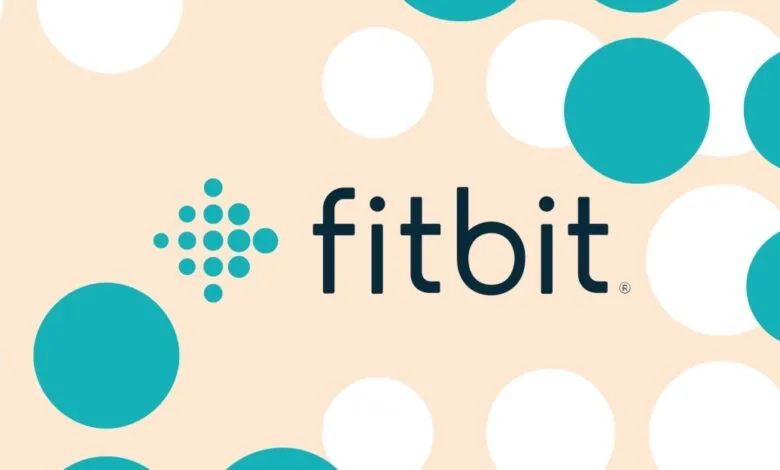 Fitbit logo on a background of teal and white circles.