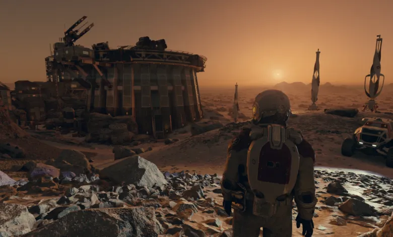 Astronaut looks toward a base on a rocky, orange alien planet.