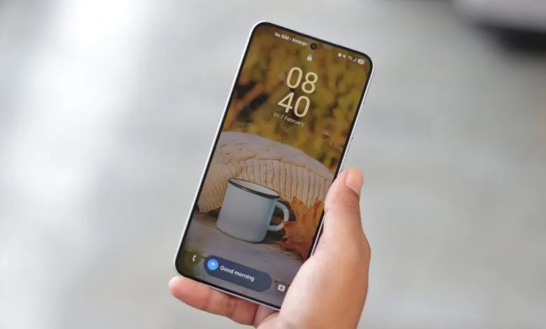 Hand holding smartphone displaying a cozy lock screen image.