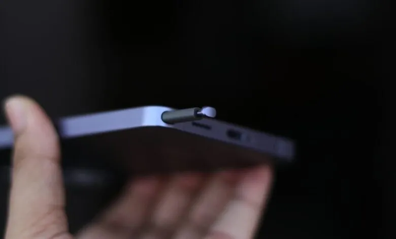 Close-up of a phone with an S Pen stylus being inserted.