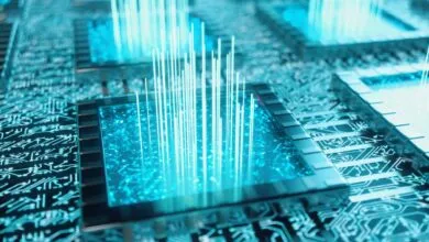 Close-up of a computer chip with glowing blue light and circuit patterns.