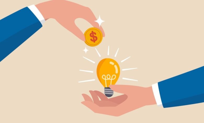 Hand placing dollar coin above a glowing lightbulb held in another hand.