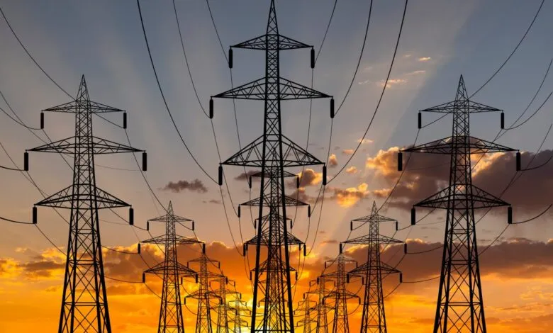 Silhouette of power lines against a vibrant sunset sky.