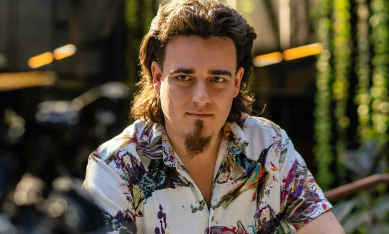 Palmer Luckey, Anduril founder, poses in colorful shirt.