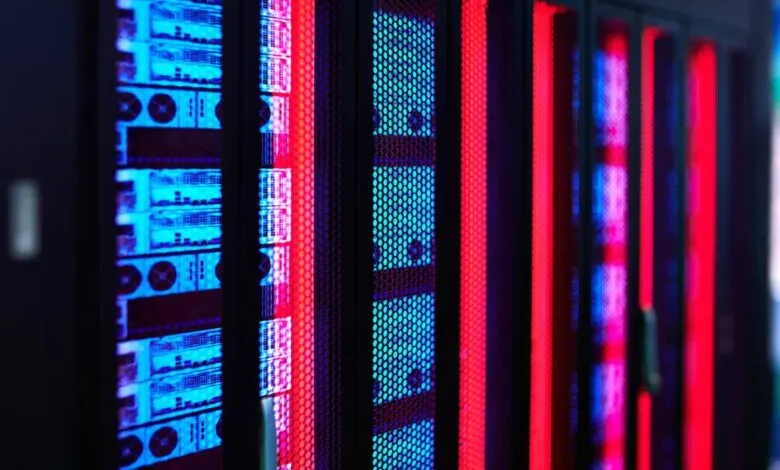 Close-up of server racks with blue and red lights, showing data center equipment.