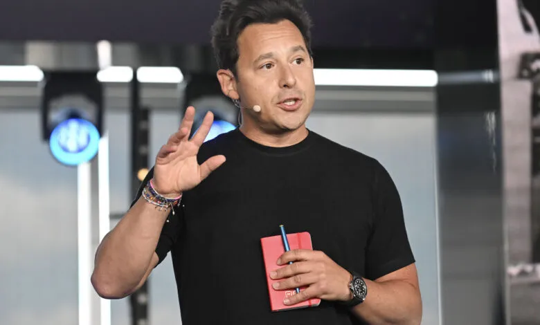 Harley Finkelstein, Shopify President, speaks with hand raised.