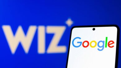 Smartphone displays Google logo with Wiz logo in the background.