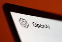Close-up of a screen displaying the OpenAI logo and text.