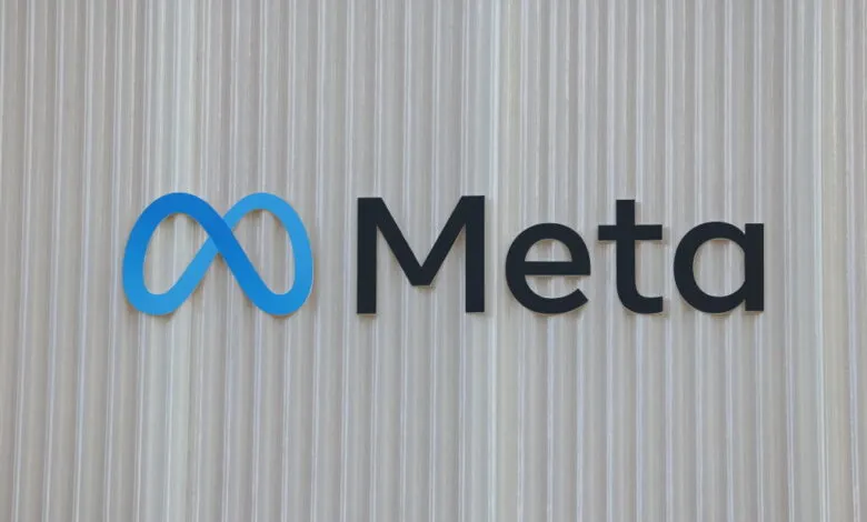 The Meta logo, a blue infinity symbol and the word 'Meta' in black, on a textured wall.