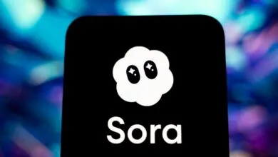 Sora app logo on a phone screen, cloud icon with star eyes.
