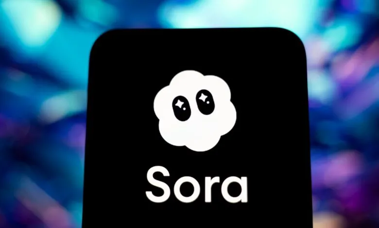 Sora app logo on a phone screen, cloud icon with star eyes.