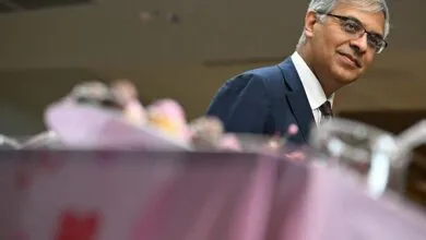 Jayanta Bhattacharya at NIH event, wearing suit and glasses.