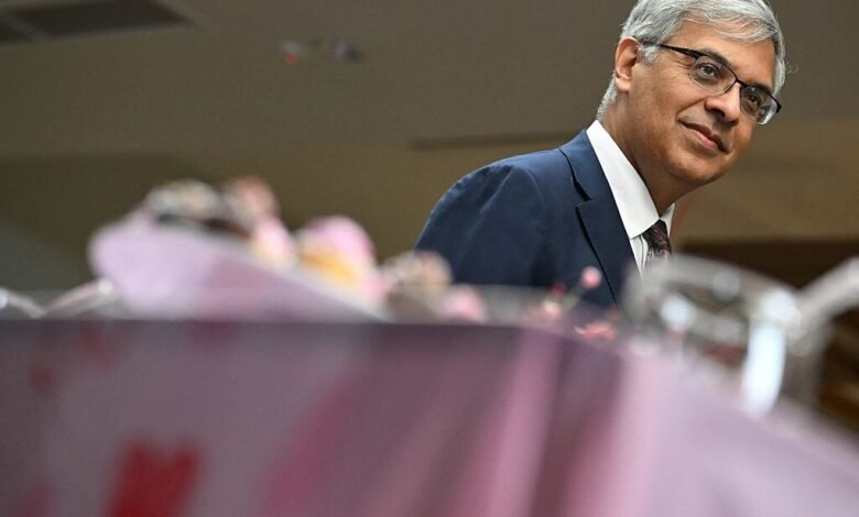 Jayanta Bhattacharya at NIH event, wearing suit and glasses.