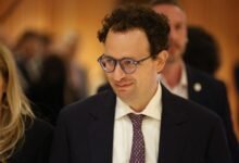 Nathaniel Gleicher at an event, wearing glasses and a suit.