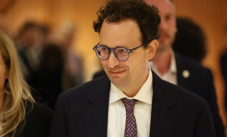 Nathaniel Gleicher at an event, wearing glasses and a suit.