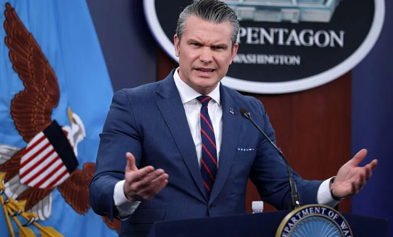 Pete Hegseth speaks at a Pentagon press conference, gesturing with hands.