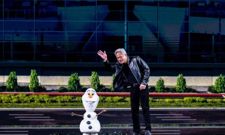 Jensen Huang waves next to Olaf on stage at event.