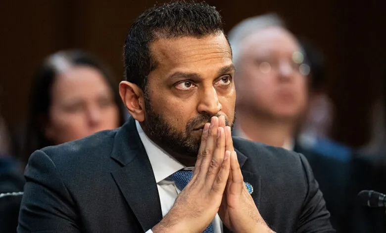 Kash Patel with hands clasped at Senate hearing.