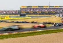 Formula 1 cars race on track at Suzuka during the Japanese Grand Prix.