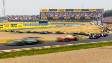 Formula 1 cars race on track at Suzuka during the Japanese Grand Prix.