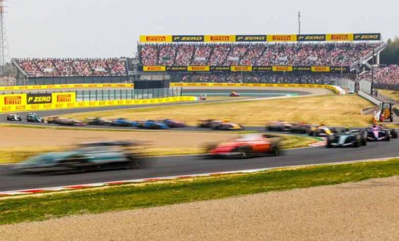 Formula 1 cars race on track at Suzuka during the Japanese Grand Prix.