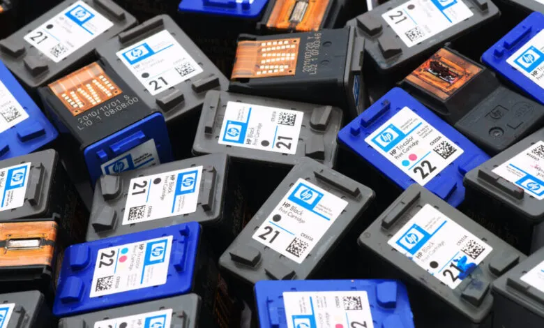 Pile of used HP 21 and 22 black and tricolor ink cartridges.