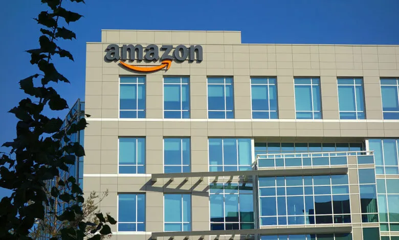 Amazon corporate building with logo against a clear blue sky.