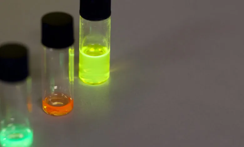 Three vials containing fluorescent liquids of different colors.