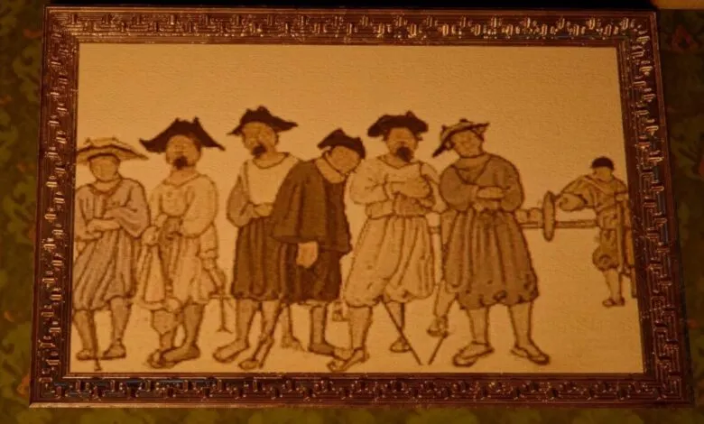 Framed tapestry depicting a group of men in historical attire.