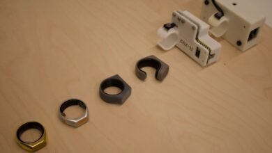 Smart rings and testing equipment on a light wood surface.