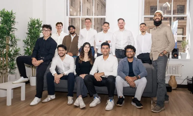 Group of diverse young professionals posing together indoors.