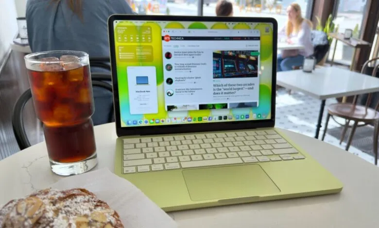 Lime green MacBook on table with iced tea and pastry, cafe setting.