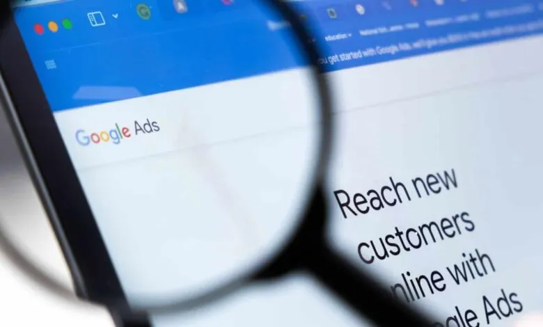 Google Ads webpage seen through a magnifying glass, focusing on customer reach.
