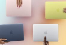 Four colorful MacBook Air laptops held by hands with different skin tones.