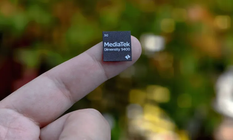 MediaTek Dimensity 9400 chip rests on a fingertip, showcasing its small size.