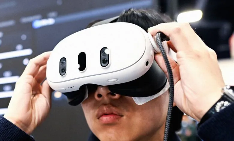 Person wearing a white VR headset with multiple cameras and sensors.