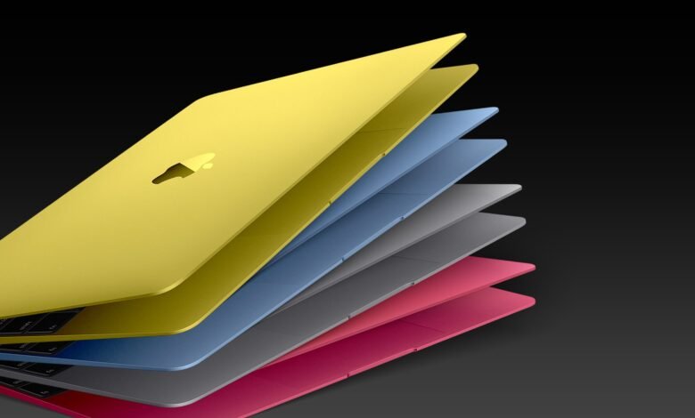 Stack of colorful MacBook laptops in yellow, blue, gray, and pink.