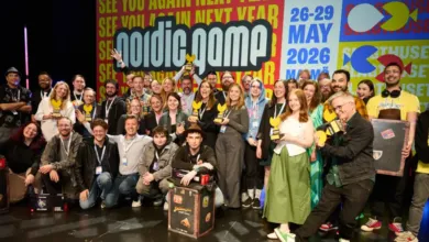 Group of people posing with awards at the Nordic Game conference, smiling.