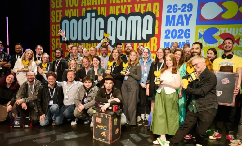 Group of people posing with awards at the Nordic Game conference, smiling.
